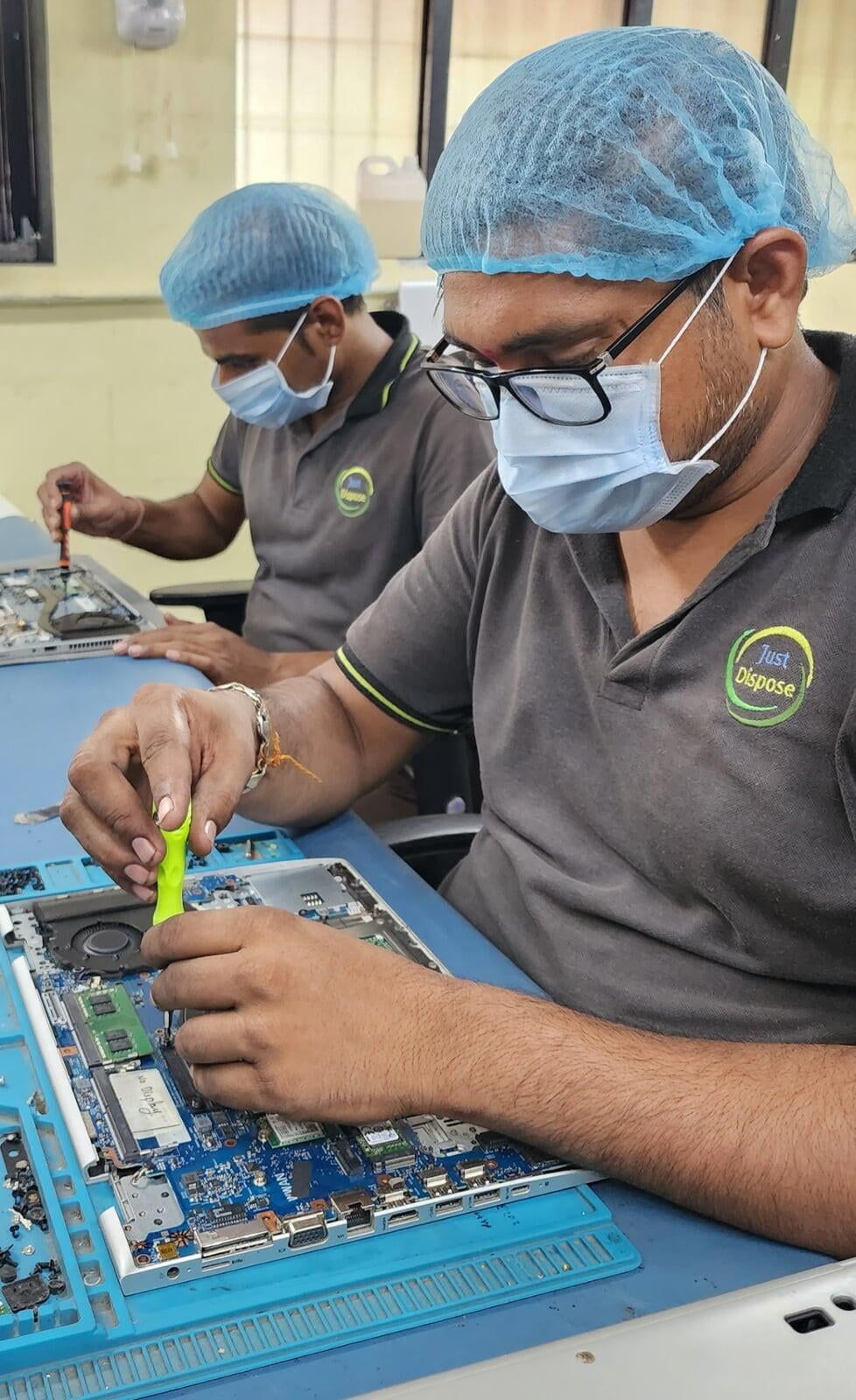 Engineers repairing laptops at Justdispose. Expert ITAD and e-waste recycling services for a sustainable future.